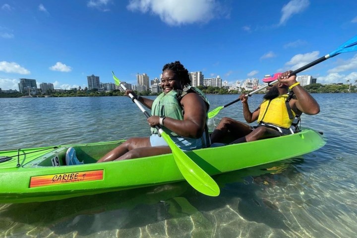 a person in a green boat on a body of water