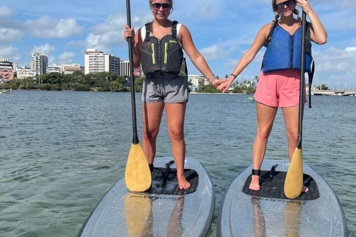 a couple of people that are standing in the water