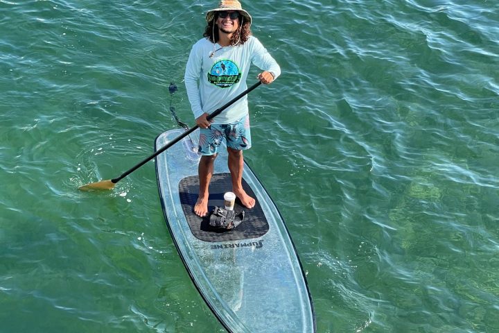 a man riding a surf board on a body of water